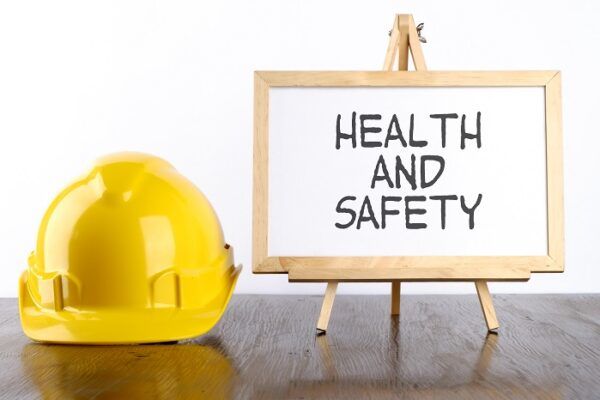 Safety helmet and white board with words Health and Safety,Health and Safety concept. Safety helmet and white board with words Health and Safety,Health and Safety concept.